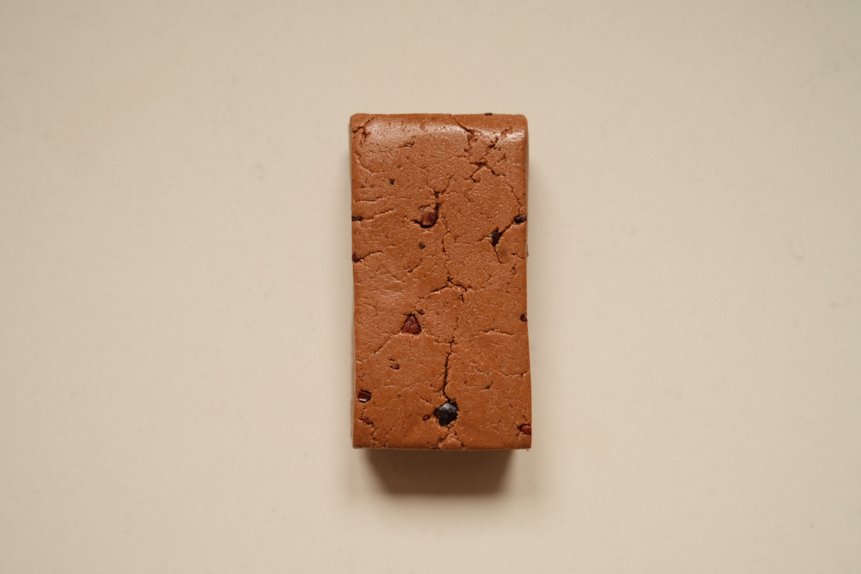 Dark Cacao bar viewed from above, showing its dense texture and cacao nibs
